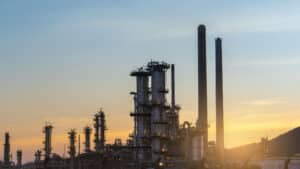 Distillation tower at sunset. fluid catalytic cracking distillation unit. Refractory Anchors for FCCU, Reformer and Heater Linings - Refractory Anchors Inc
